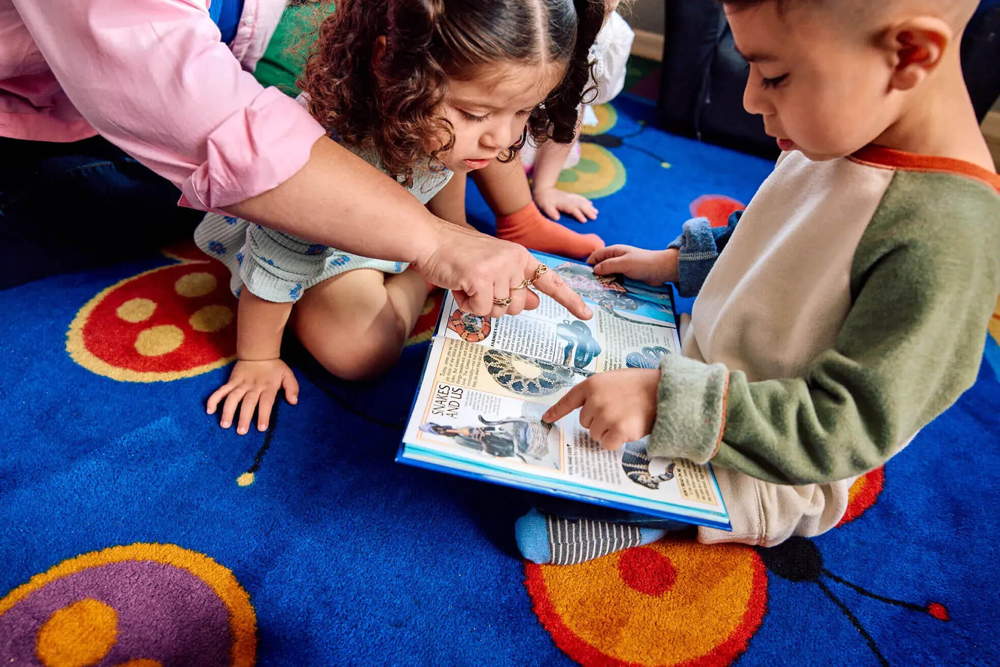 Children reading a book.
